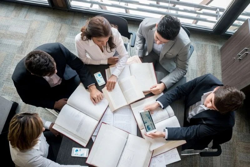 a-group-of-business-people-sitting-around-a-table