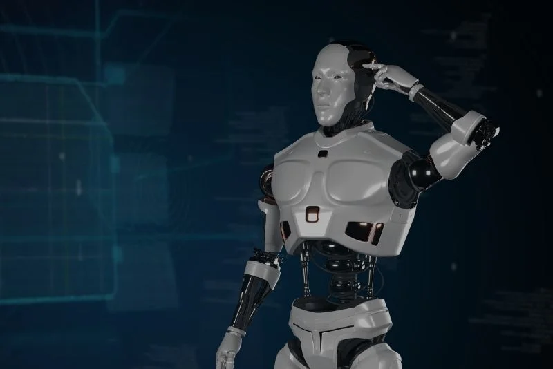 a-robot-is-standing-in-front-of-a-computer-screen